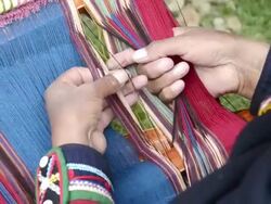 CU ZO Sitting woman weaving yarn / Cuzco or Cusco, Peru Stock Footage