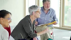 People talking in circle in group meeting Stock Footage