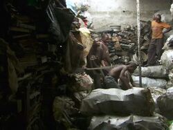 WS View of men sorting scrap metal into bags for weighing / Lagos, Nigeria Stock Footage