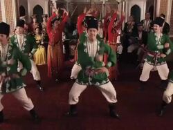 A group of men and women dancing in a hall, with an orchestra of men and women behind them. Stock Footage
