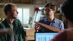 Wood shop owner teaches young workers about designing and crafting custom skateboards Stock Footage