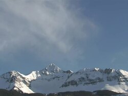 MS T/L View of Clouds and Snow Rolling over Majestic Mountain Peaks in evening Light / Telluride, Colorado, United States Stock Footage