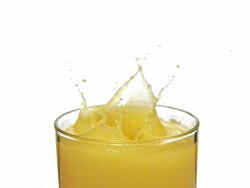 CU SLO MO Ice cube falling into glass of orange Juice / Vieux, Normandy, France   Stock Footage
