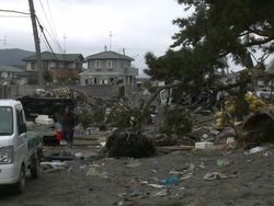 Destruction caused by tsunami after magnitude 9 Tohoku earthquake, north east Japan, March 2011. Man walks through residential area trashed by tsunami Stock Footage