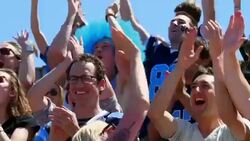 MS Crowd of football fans standing out of seats cheering in stadium Stock Footage