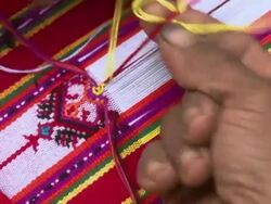 ECU Shot of Fingers weaving beautiful garment / Soe, Mt. Mutis, West Timor Indonesia Stock Footage