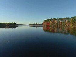 POV Gliding through St. George river, surrounded by lush, colorful foliage reflecting in the water / Mount Desert Island, Maine, United States Stock Footage