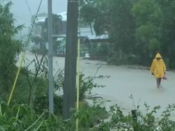 Man walking through flooded road, 60km NE of Laoag, Philippines, typhoon Parma 4th October 2009 Stock Footage