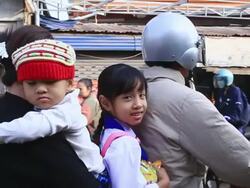 MS POV SLO MO Parents andchildren on motorbike passing through street / Vientiane, Laos Stock Footage
