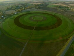 Aerial oblique shot of large crop irrigation circle near Bozeman, MT Stock Footage