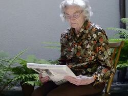 MS Old woman reading newspaper in garden / Landshut, Bavaria, Germany Stock Footage