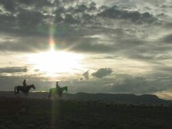MS PAN American Indian Native Couple Horse Back Riding at Spectacular New Mexico and Mountains under Sky at sun set  / Santa Fe, New Mexico, United States Stock Footage