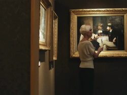 mature couple at an art museum looking at paintings Stock Footage