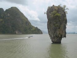 traveling boat pass trough Ko Tapu island in rainy day. Stock Footage