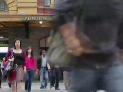 MS T/L Crowds of pedestrians cross busy city street as traffic stops at flinders street station / Melbourne, Victoria, Australia Stock Footage