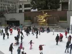 WS Crowds watching people skating at Rockefeller Plaza / New York City, New York, USA Stock Footage