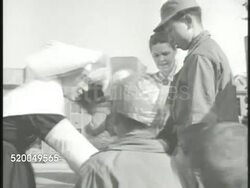 1951: KOREAN WAR: CHILDREN: VS Korean children walking on streets, nurses gathering children, INT giving children baths in tubs, washing smiling boy's face. VS Children sitting in rows, eating. Innocence, innocent, refugees Instructional Video