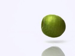 CU SLO MO Shot of Granny Smith Apple, malus domestica, Fruit Exploding against White Background / Calvados, Normandy, France Stock Footage