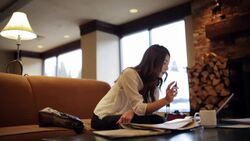 Businesswoman working at laptop in lobby Stock Footage