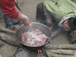 MS cooking meat over a fire / Xam Neua, Laos Stock Footage