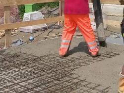 MS Shot of workmen casting concrete at house construction, building site / Hermeskeil, Rhineland Palatinate, Germany Stock Footage