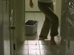 MS, TU, TD, Woman cleaning tile floor in laundry room, Hollywood, California, USA Stock Footage