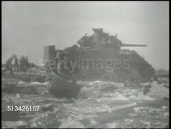 1944: BATTLE OF KWAJALEIN: VS Smoke rising from Roi-Namur island, destroyed buildings, structures, 4th Marine Division Marines & tank regiment rolling through captured airfield, destroyed hangars BG, soldiers checking damaged aircrafts. WWII, Pacific Instructional Video