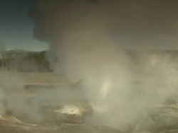 Long Shot pan-right - Clouds of steam rise from hot springs and geysers in Yellowstone National Park. / Yellowstone National Park, Wyoming, USA Stock Footage