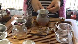 woman makes china tea for taste in market, Beijing Stock Footage