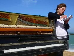 young woman writes on the coast Stock Footage