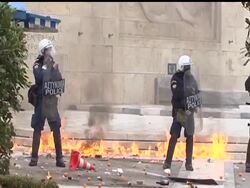 Protesting high school students hurled rocks and bottles during clashes with police Tuesday during a rally to mark the third anniversary of the fatal police shooting of a teenager in central Athens. News Clip