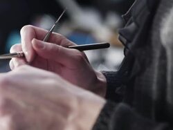 CU PAN Female make-up artist backstage applying lip color to brushes Stock Footage