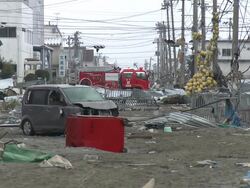 Destruction caused by tsunami after magnitude 9 Tohoku earthquake, north east Japan, March 2011. Fire truck sits at end of debris filled street in Ishinomaki City port, Miyagi Prefecture Stock Footage