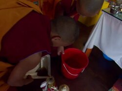 MS ZI ZO POV Buddhist monks pouring  dark liquid into ornate pouring kettles / Kathmandu, Central, Nepal Stock Footage