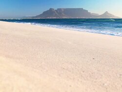 Ocean laps white beach Table Mountain Stock Footage