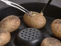 Whole potatoes backed in pan Stock Footage