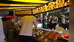 Cooking process of Hiroshima style Okonomiyaki (Japanese pancake) in Yatai Restaurant along the Approaching Road of Yasukuni Shrine Tokyo Japan. Stock Footage