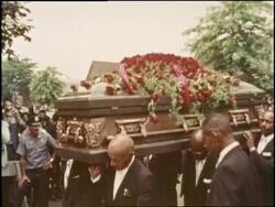 Pallbearers carry Louis Armstrong's coffin at his funeral. News Clip