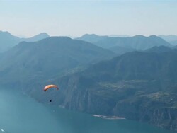 WS Hillside paraglider over landscape lake and mountais / Macesine, Verona, Italy   Stock Footage