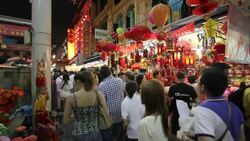 Shoppers maneuver through the Chinatown Night Market in Singapore. Stock Footage