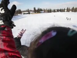 School children tobogganing down a playground hill during winter recess Stock Footage