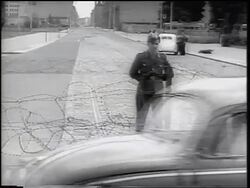 B/W 1961 soldier guarding barbed wire fence of Berlin Wall / Germany / newsreel Stock Footage