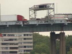 Trailer on suspension bridge Stock Footage