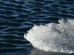 MS Melting glacier floating and moving on jokulsarlon lake wind making ripples at lake / Iceland Stock Footage