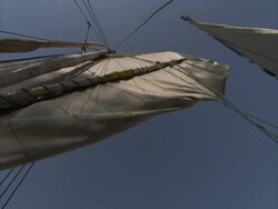 Fishing boat sail being unravelled with clear blue sky in background, El Bizri, Egypt (sound available) Stock Footage