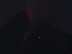 Lave spills from the crater of erupting volcano at night, Philippines, Dec 2009 Stock Footage