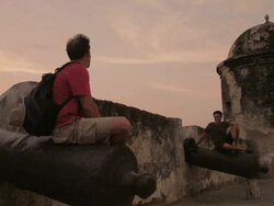 MS Travelers resting on fortress canions at sunset time / Cartagena, Bolivar, Colombia    Stock Footage