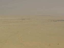 WS AERIAL View of electricity and mobile tower and cars moving on highway in desert / Qatar Stock Footage