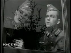 1941: SWEDEN TROOP TRAIN DEAL: Train pulling out of check-point, allowing Nazi German train to pass. Swedish soldier looking over platform edge. Swedish soldiers rolling barbed wire barricade back over track.  WWII, Active neutrality. Instructional Video
