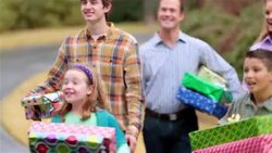 Excited family with presents arrive at grandma's house for Christmas, grandma hugs grandson Stock Footage